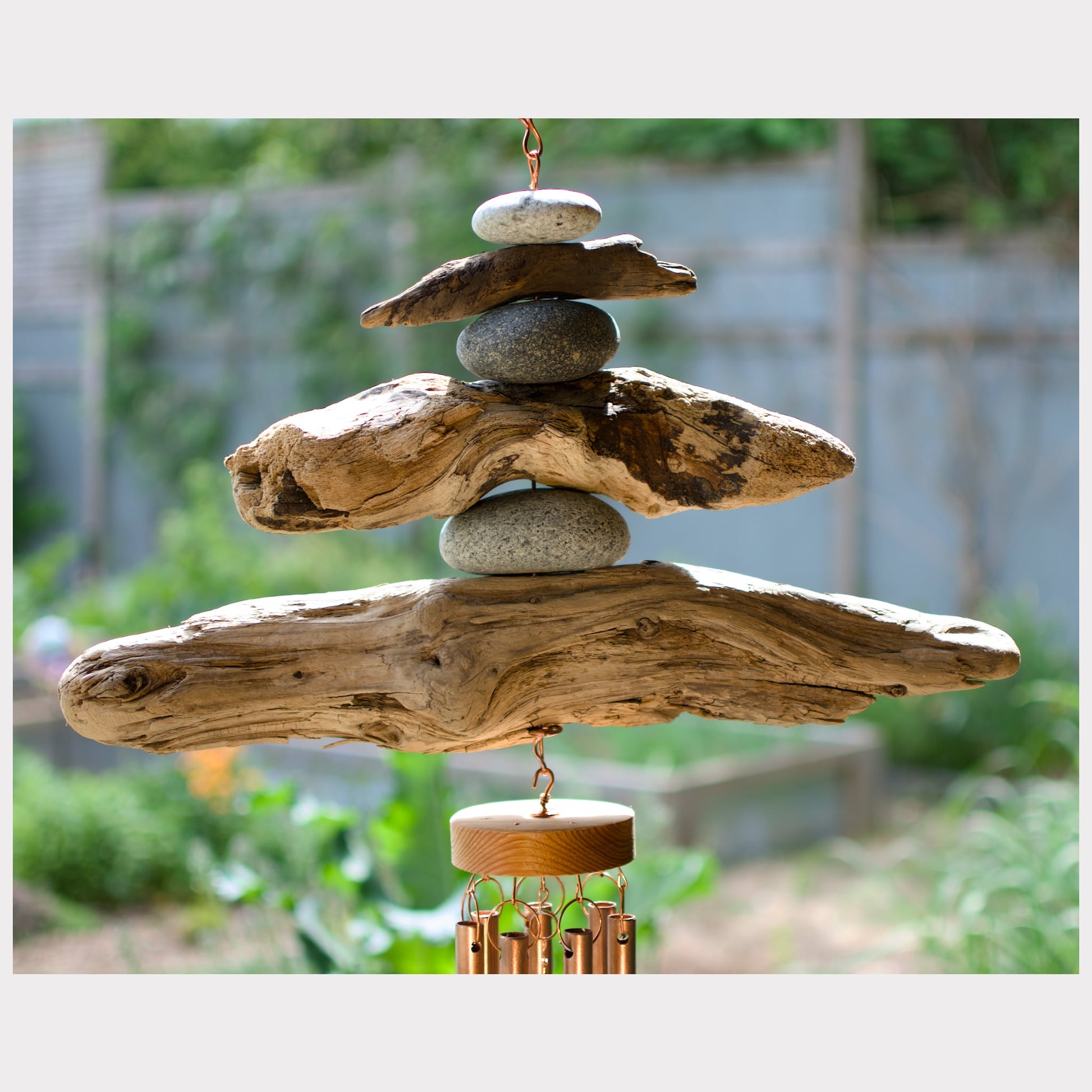 detail, driftwood and beach stone wind chime
