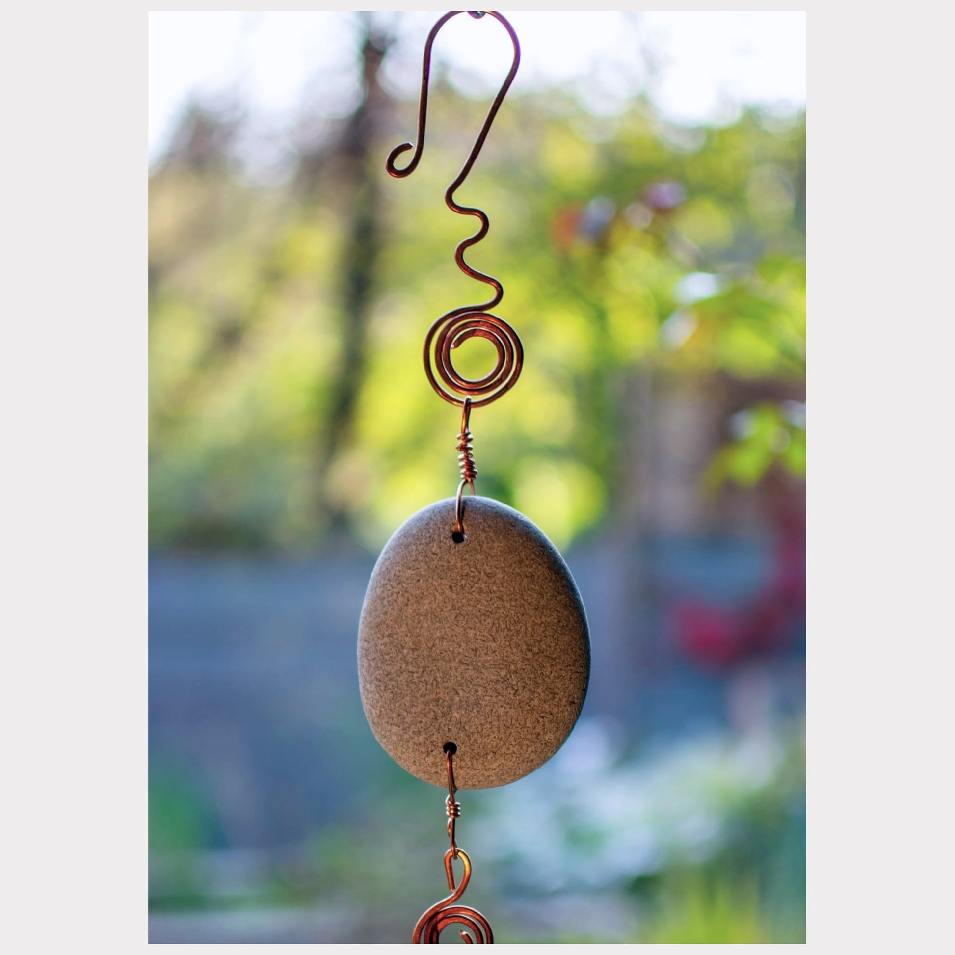 detail, beach stone wind chime with a fancy hammered copper hook