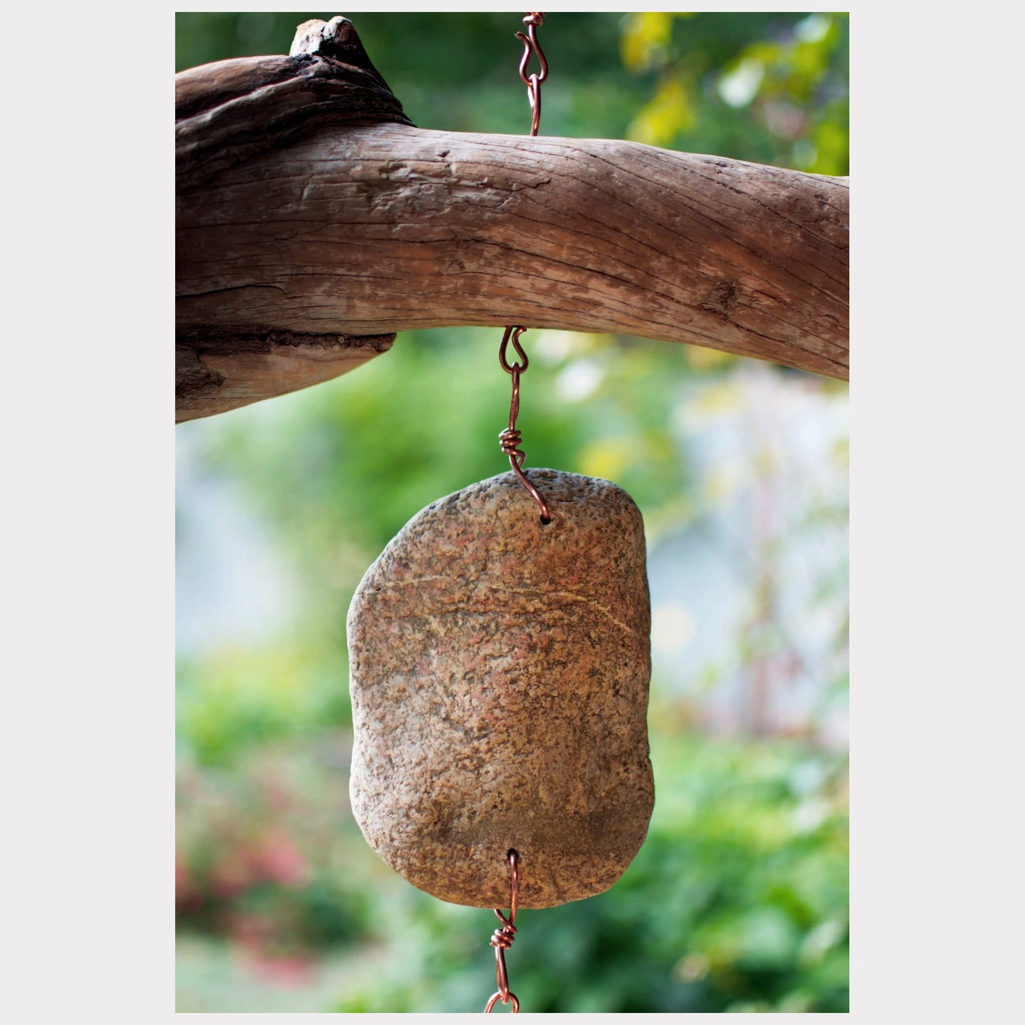 zoom detail, driftwood and beach stone wind chime