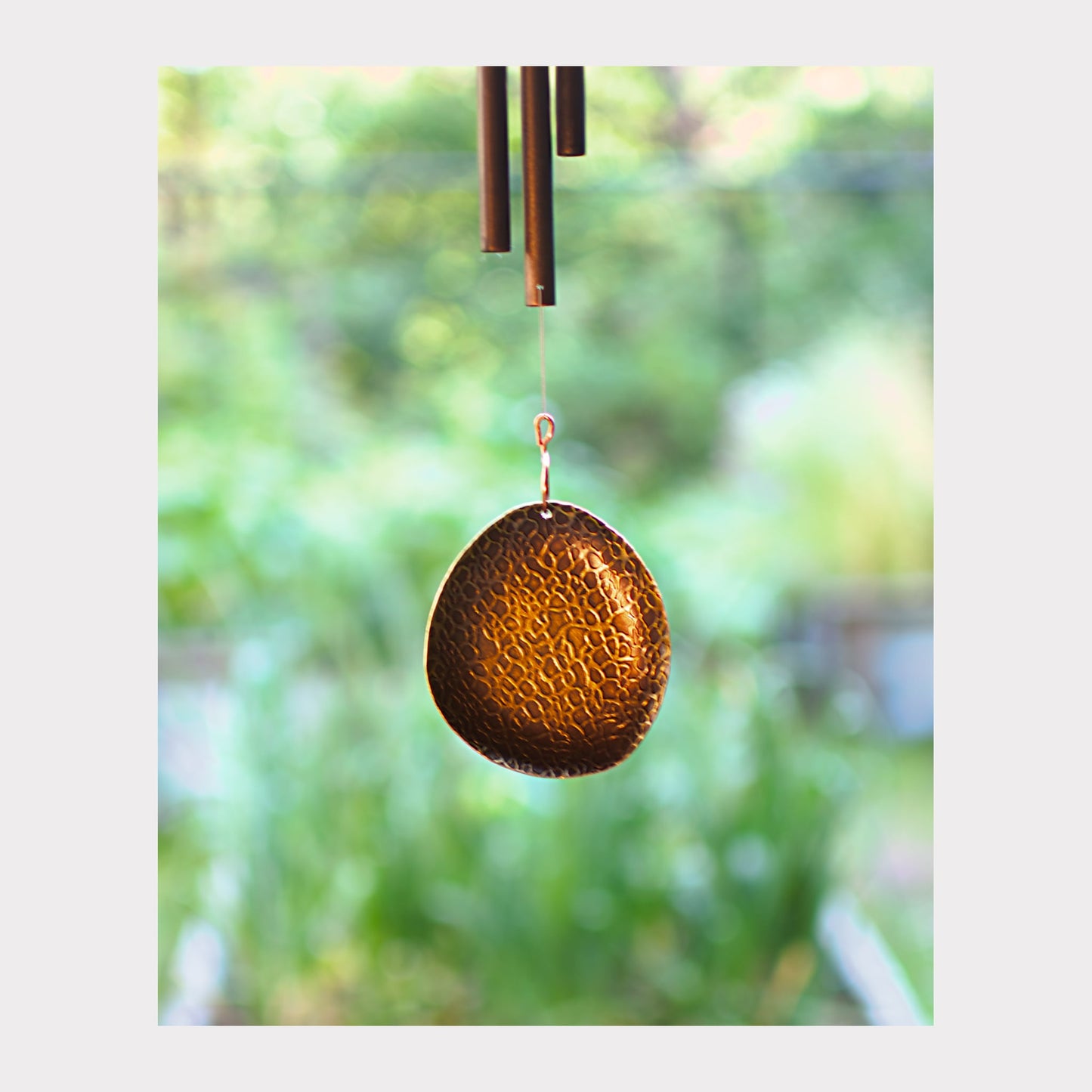 Detail, antiqued metal windsail for a wind chime.