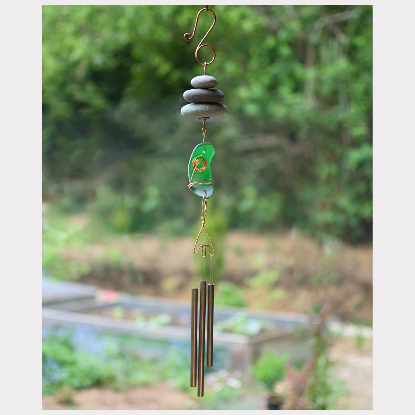Zen wind chime featuring three natural beach stones, artist-made sea glass, and three brass chimes.