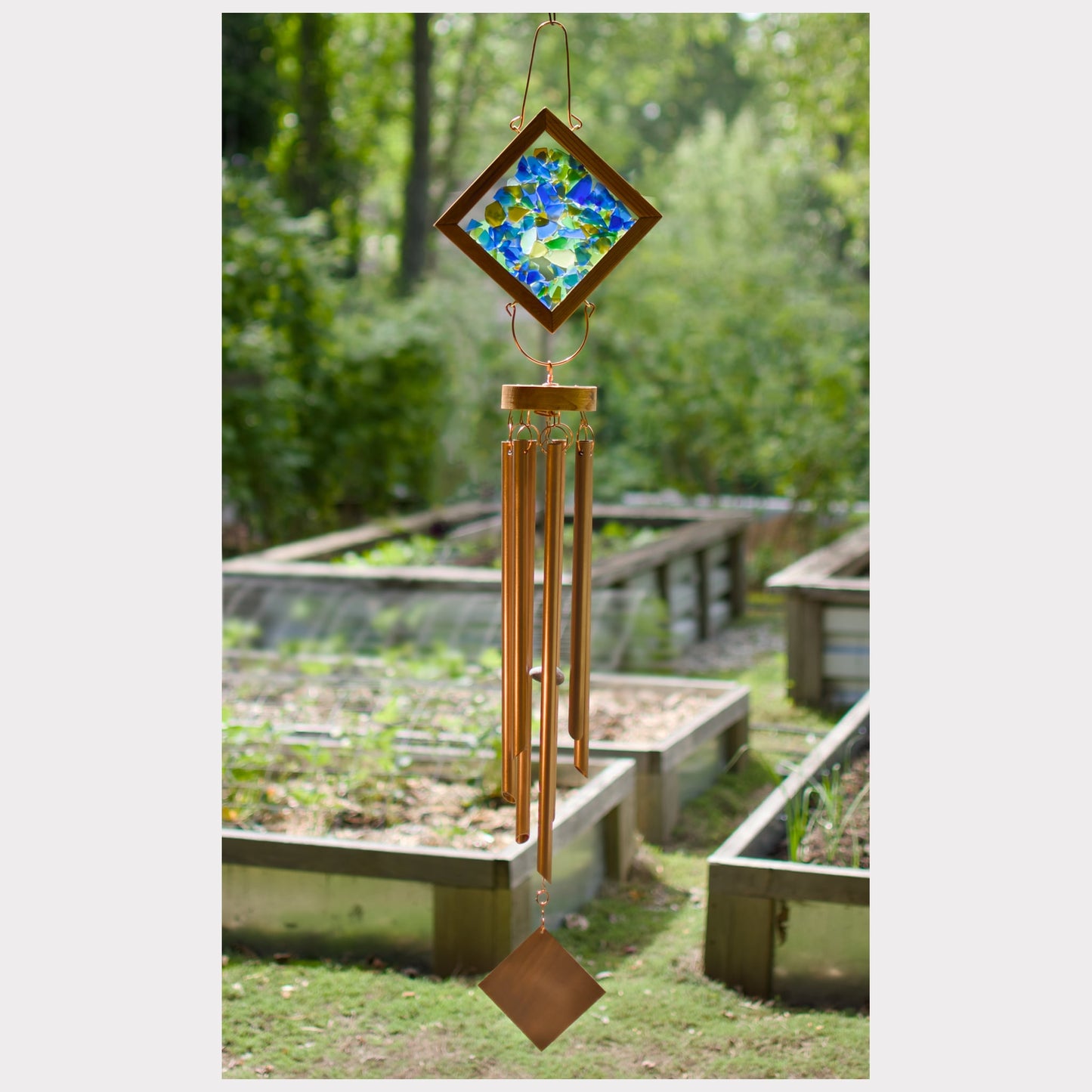 Kaleidoscope wind chime featuring artist-made beach glass and seven copper chimes.