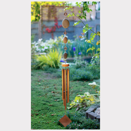 Large natural beach stone wind chime with five copper chimes.