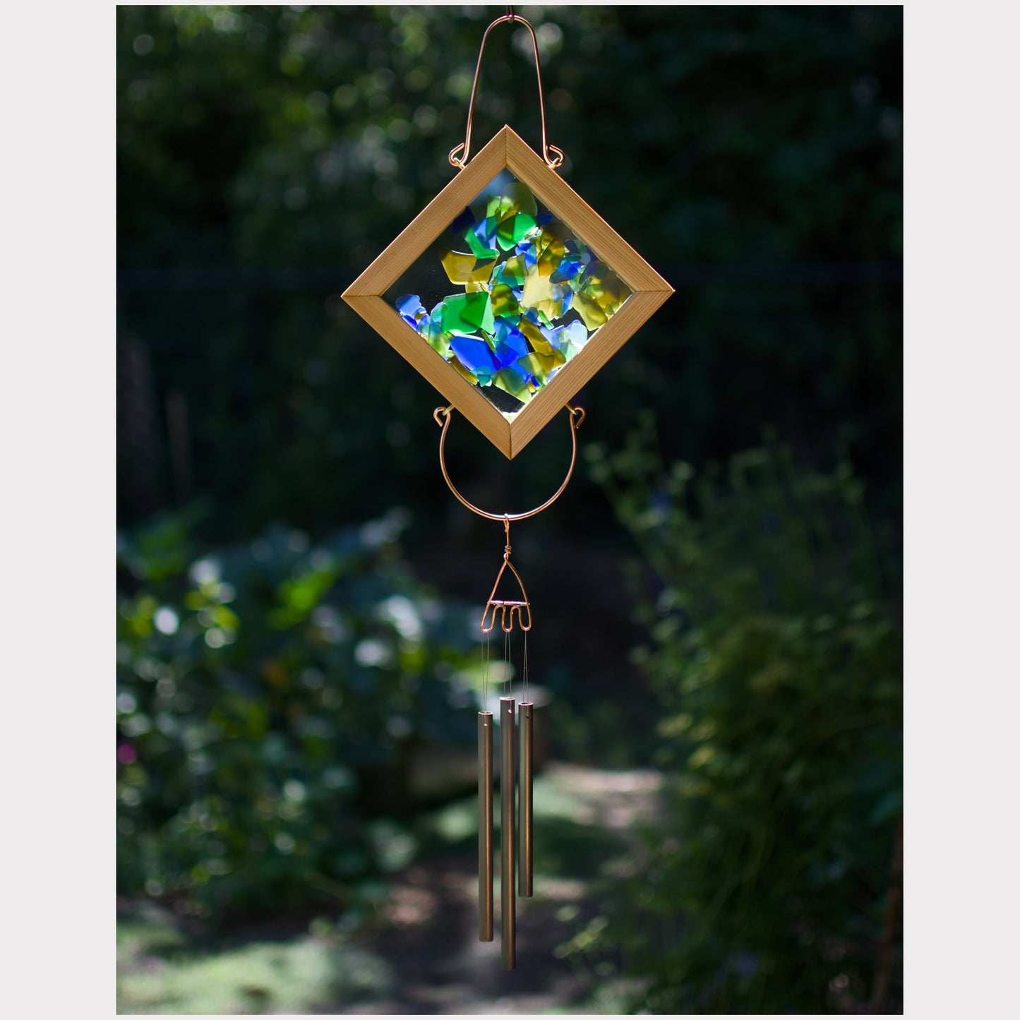 Kaleidoscope wind chime featuring artist-made beach glass and 3 handmade antiqued brass chimes.