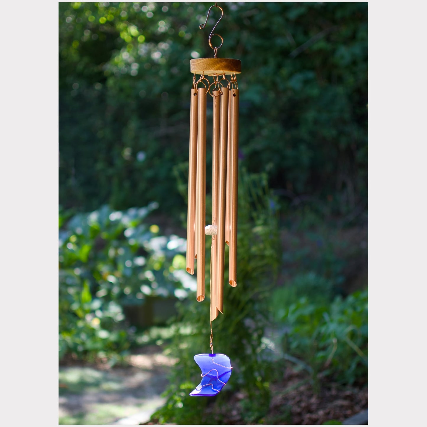 Handmade wind chime featuring 7 genuine copper chimes and an artist-made beach glass windsail.