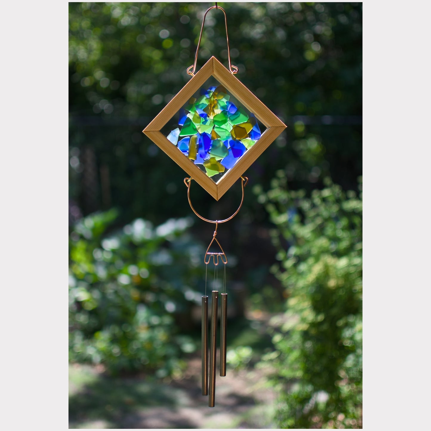 Kaleidoscope wind chime featuring artist-made beach glass and 3 handmade antiqued brass chimes.