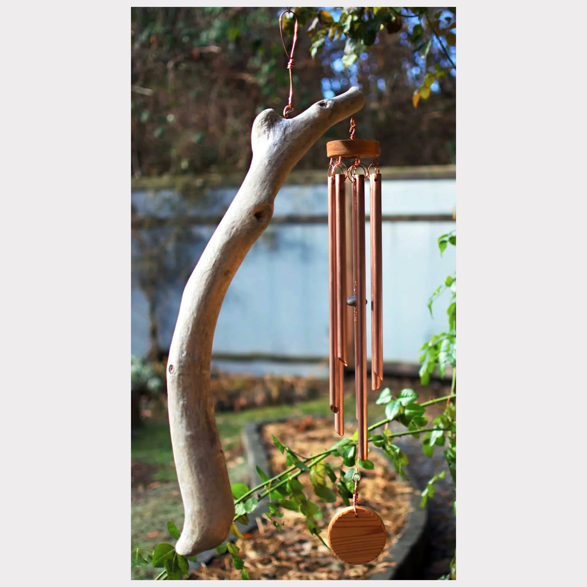 Large natural driftwood wind chime with seven copper chimes.