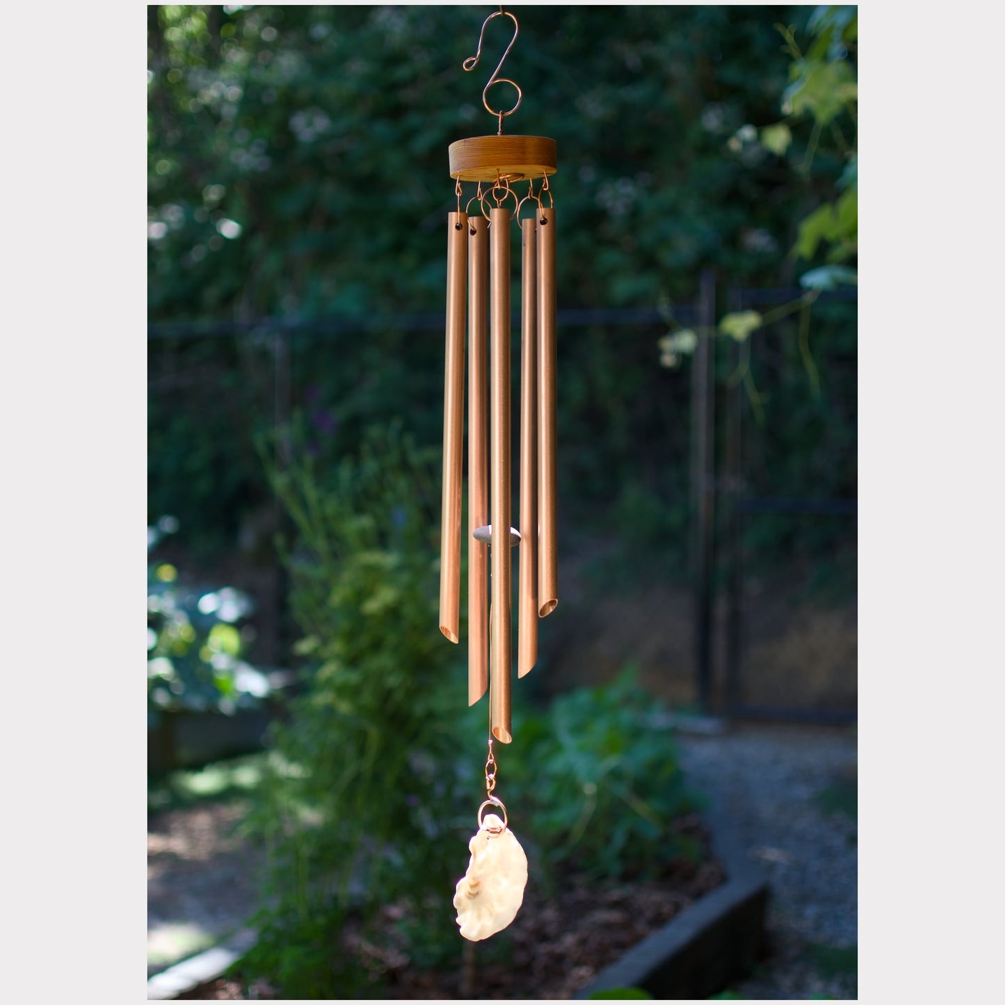 Handmade wind chime featuring 5 real copper chimes and an oyster half shell windsail.