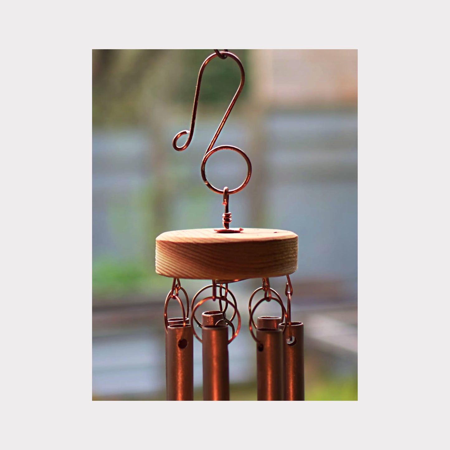 top of a handcrafted copper wind chime showing handmade hardware