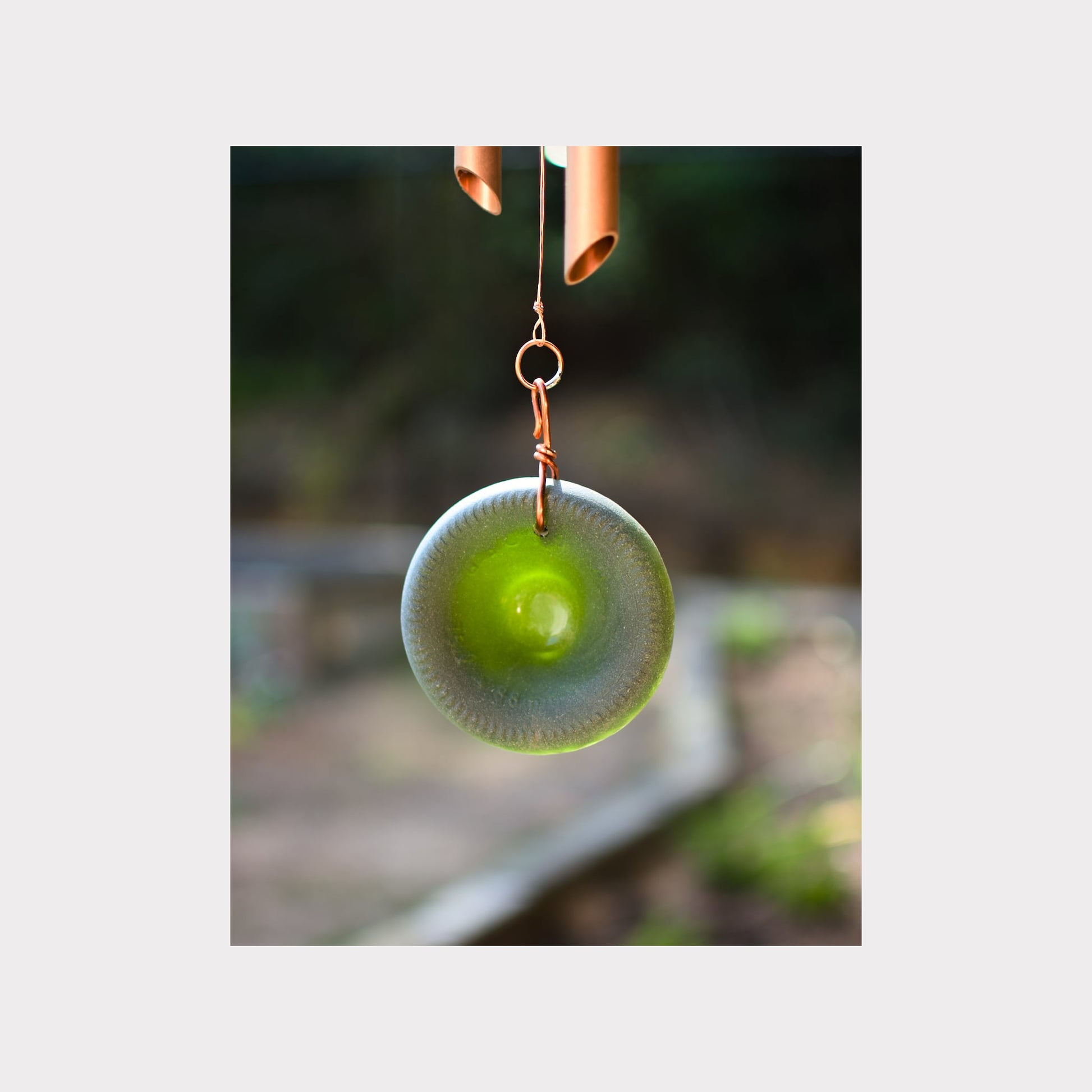 detail, green glass windsail for a copper wind chime.