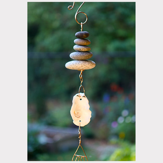 Detail, zen beach stone and oyster half shell wind chime.