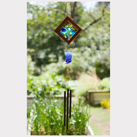 Decorative wind chime with colorful glass elements in a garden setting