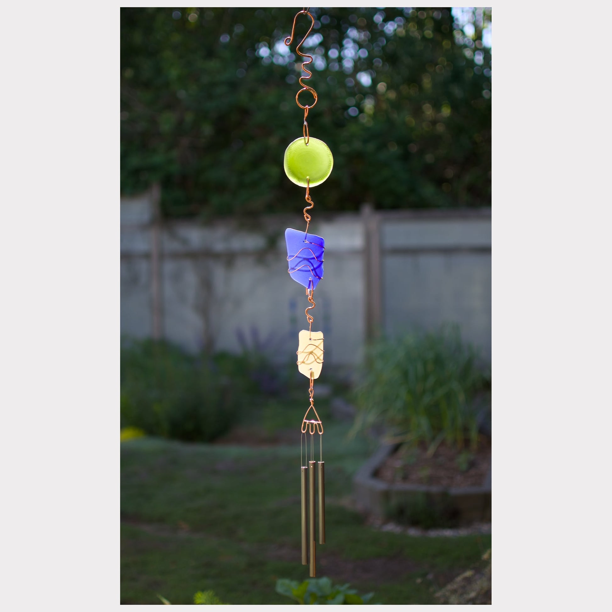 Sea glass wind chime with three brass chimes and a fancy hammered copper hook.