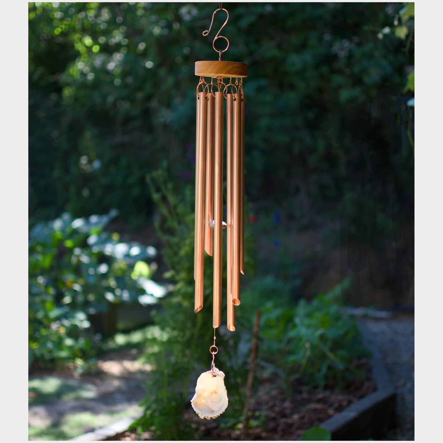 Handmade wind chime featuring 7 genuine copper chimes and an oyster half shell windsail.
