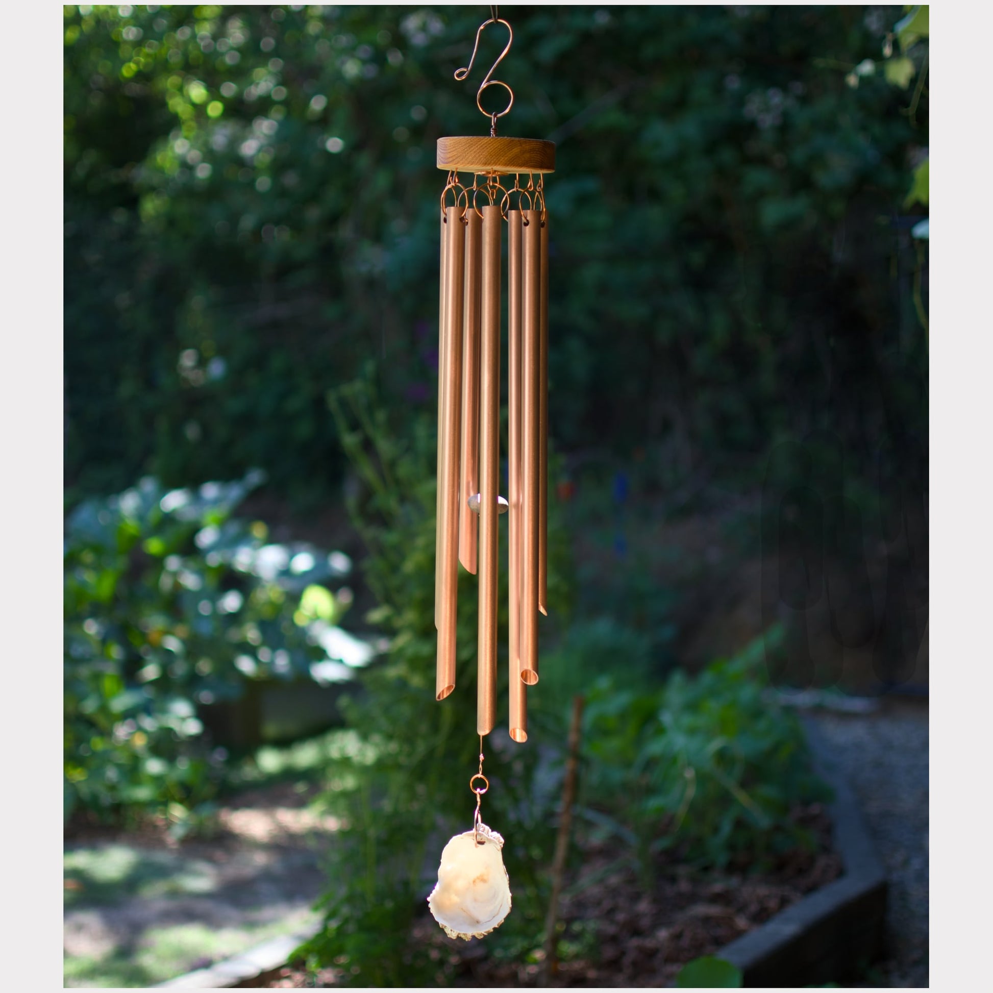 Handmade wind chime featuring 7 genuine copper chimes and an oyster half shell windsail.