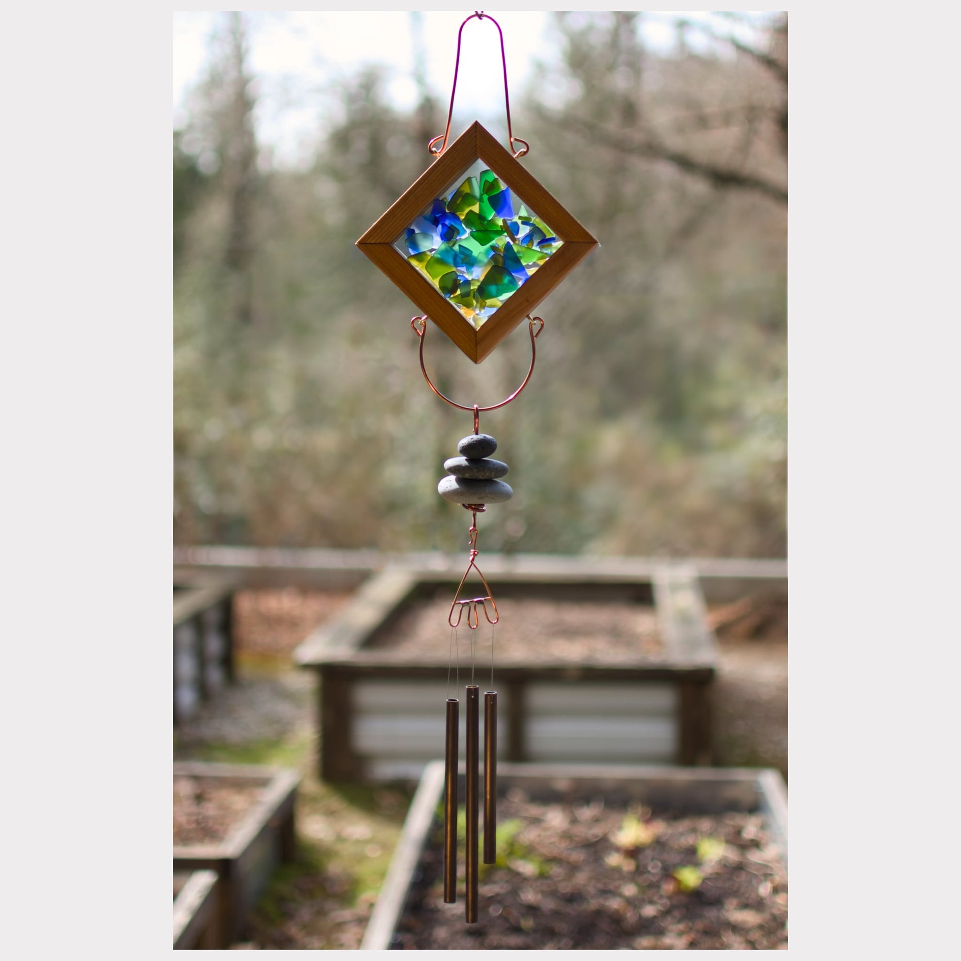 Kaleidoscope wind chime featuring artist-made beach glass, beach stones, and three natural beach stones.