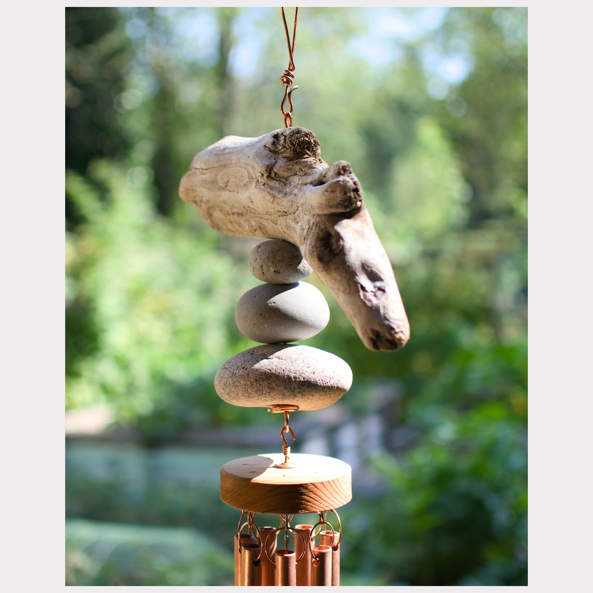 sideview, driftwood and beach stone wind chime
