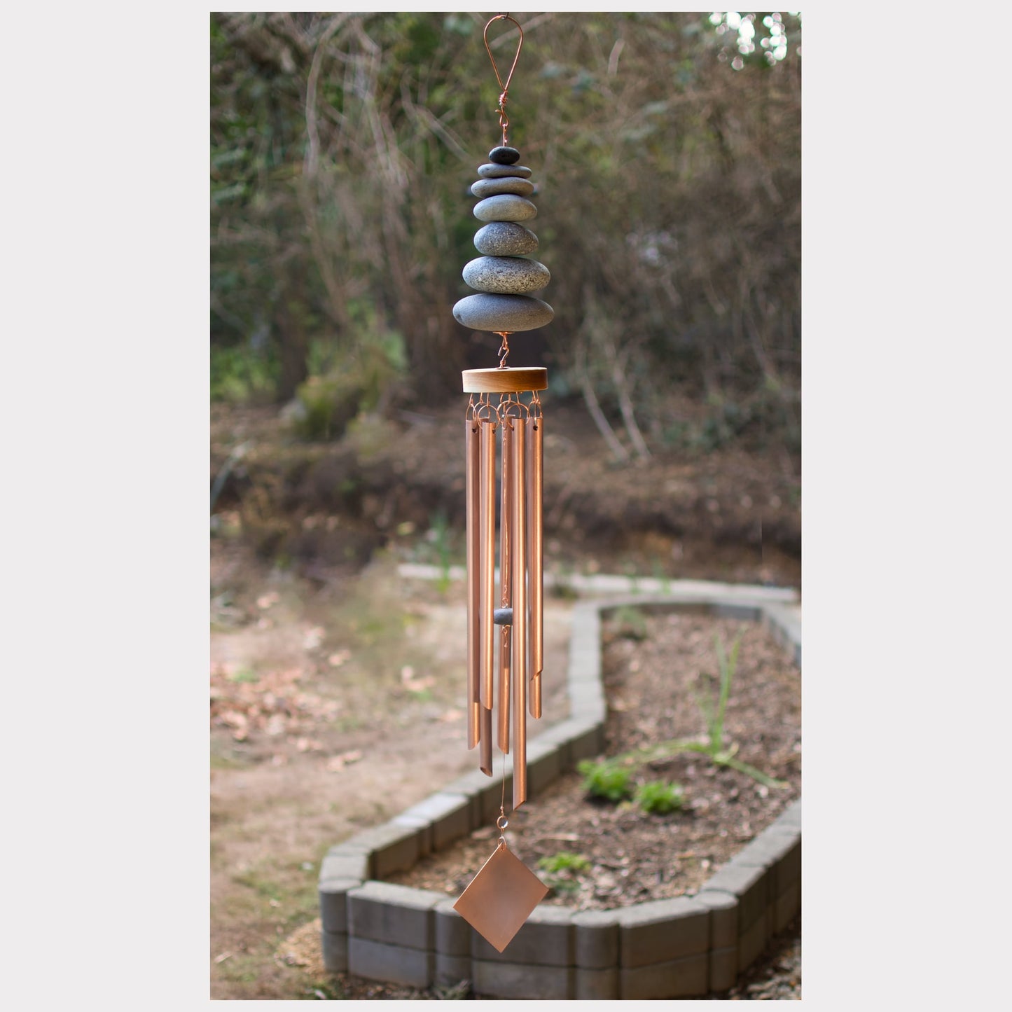 Zen wind chime featuring seven natural beach stones and seven genuine copper chimes.