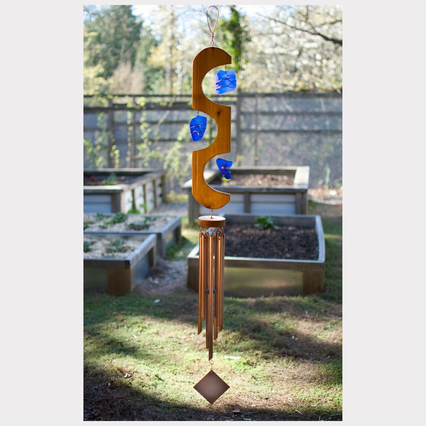 Cedar and cobalt blue sea glass wind chime with seven copper chimes.