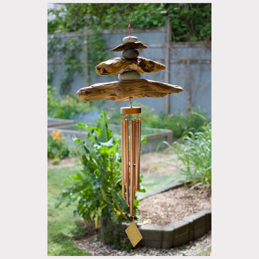 Large driftwood and beach stone wind chime with seven copper chimes.