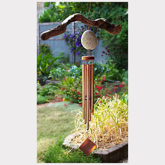 Rustic handmade driftwood and beach stone wind chime with seven copper chimes.