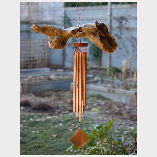 Large driftwood wind chime with seven copper chimes.