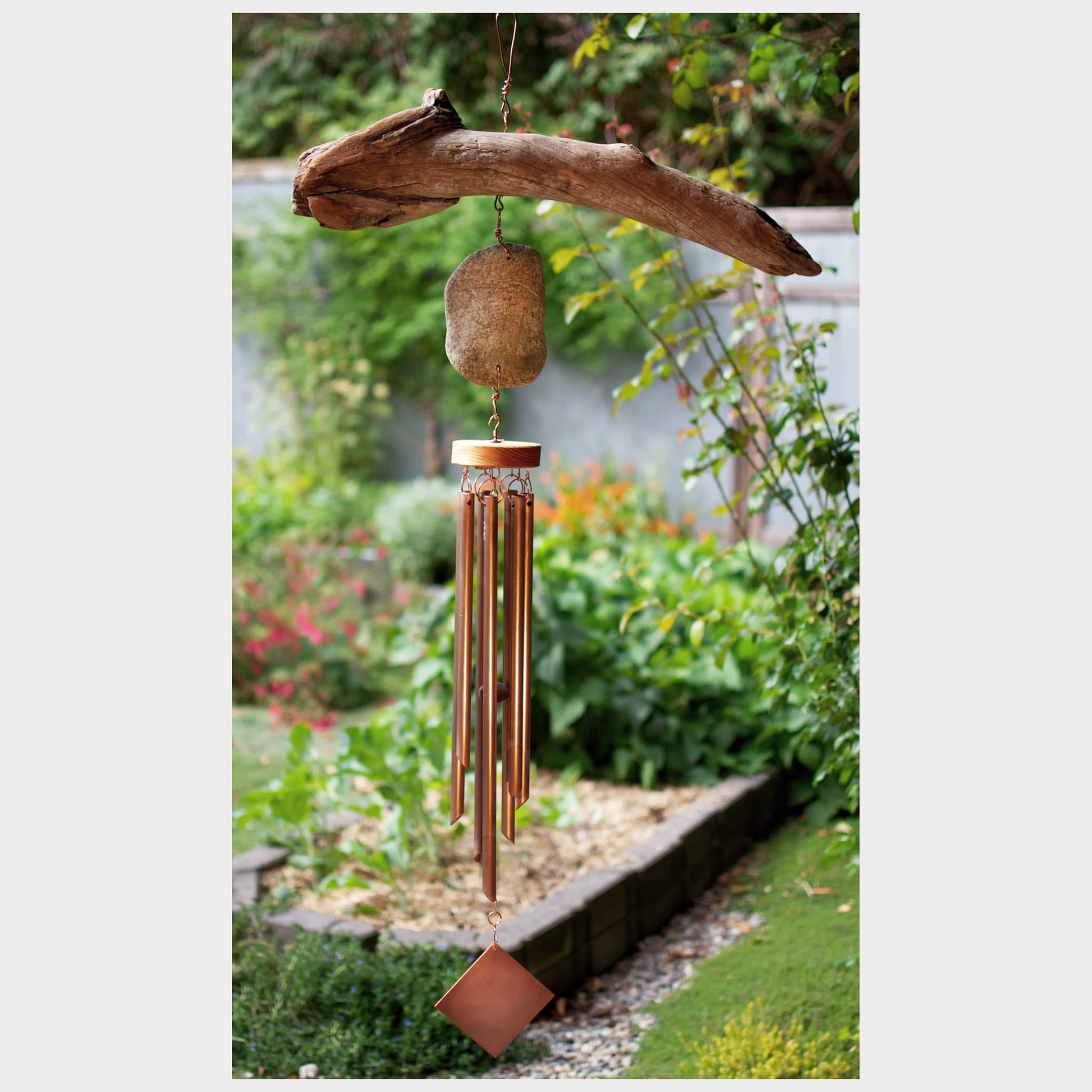 Large driftwood and beach stone wind chime with seven copper chimes.