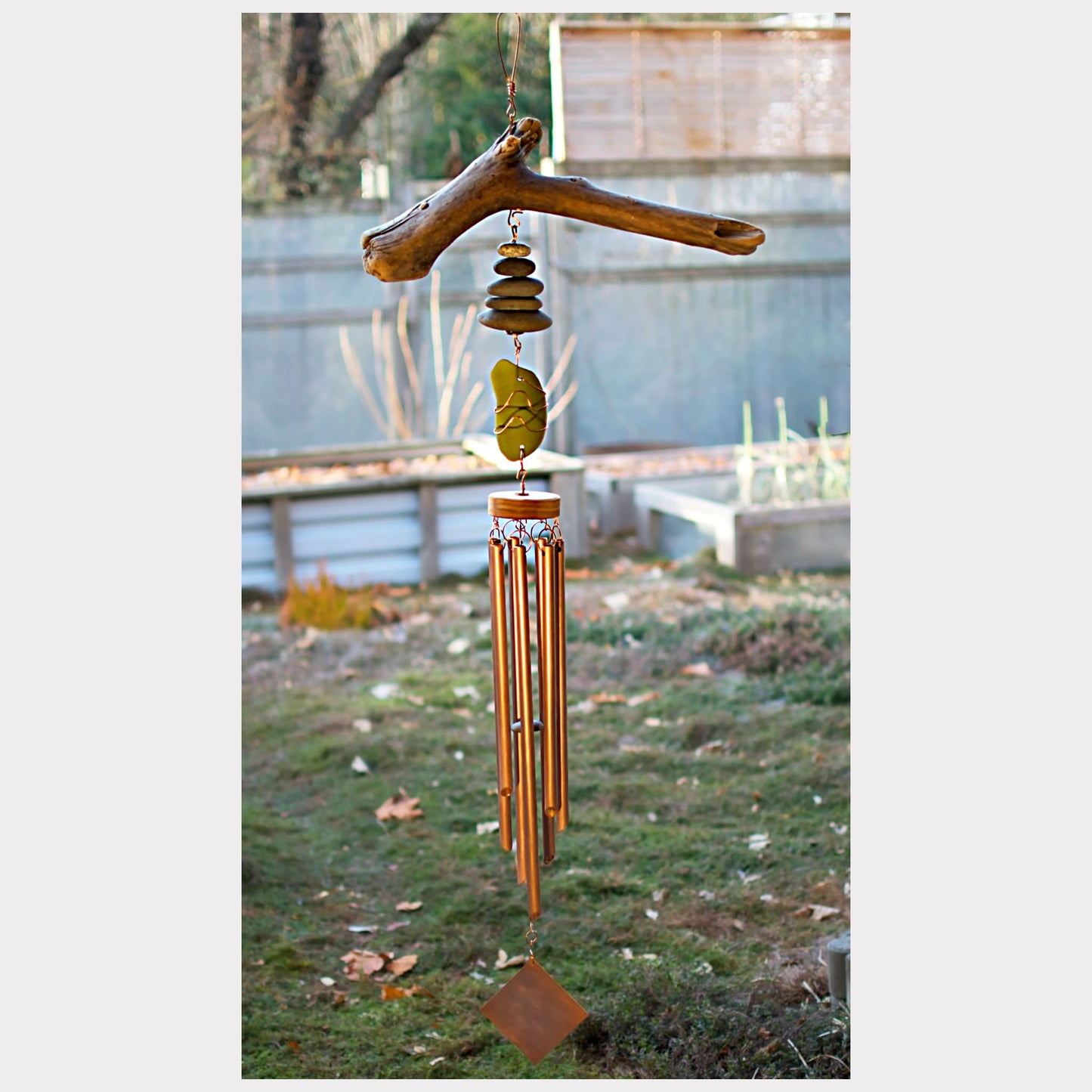 Coastal driftwood, beach stone, sea glass wind chime with seven copper chimes.