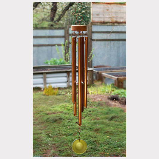 Handmade copper wind chime with a yellow sea glass windsail.