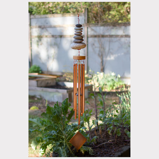 Zen natural beach stone wind chime with five copper chimes.