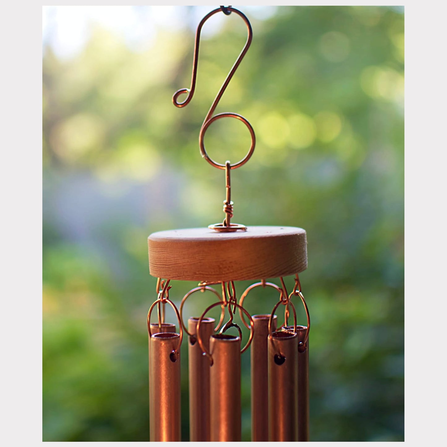 detail, top of a handmade copper wind chime with a copper hook