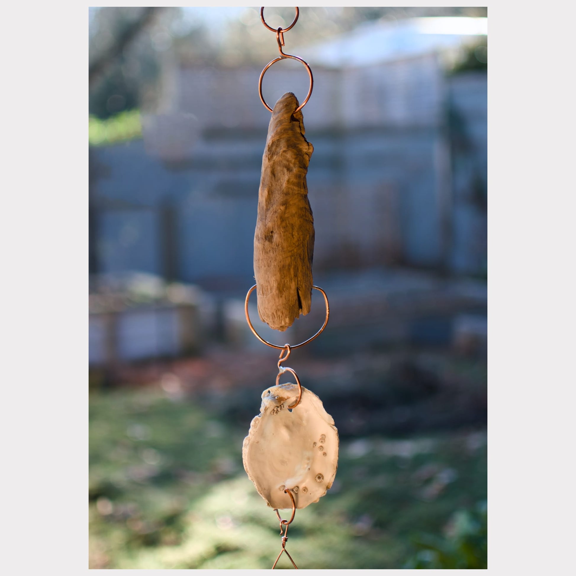 detail driftwood and oyster shell wind chime