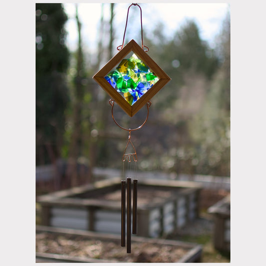 Kaleidoscope wind chime featuring artist-made beach glass and three antiqued brass chimes.