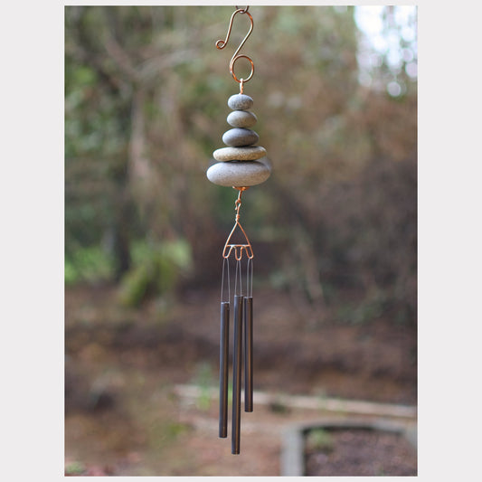 Zen wind chime featuring five beach stones and three antiqued brass chimes.