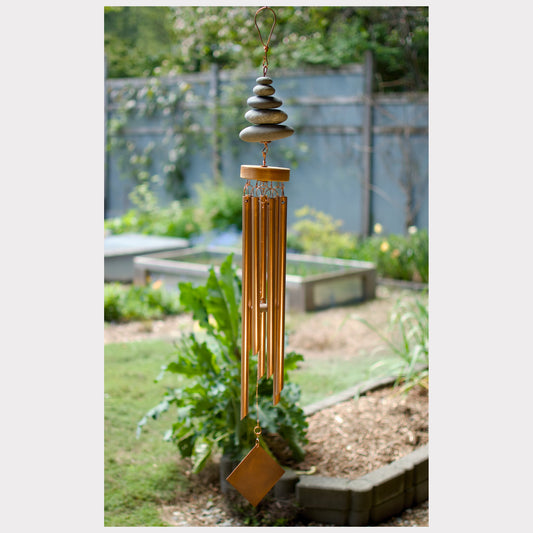 Large zen beach stone wind chime with seven copper chimes.
