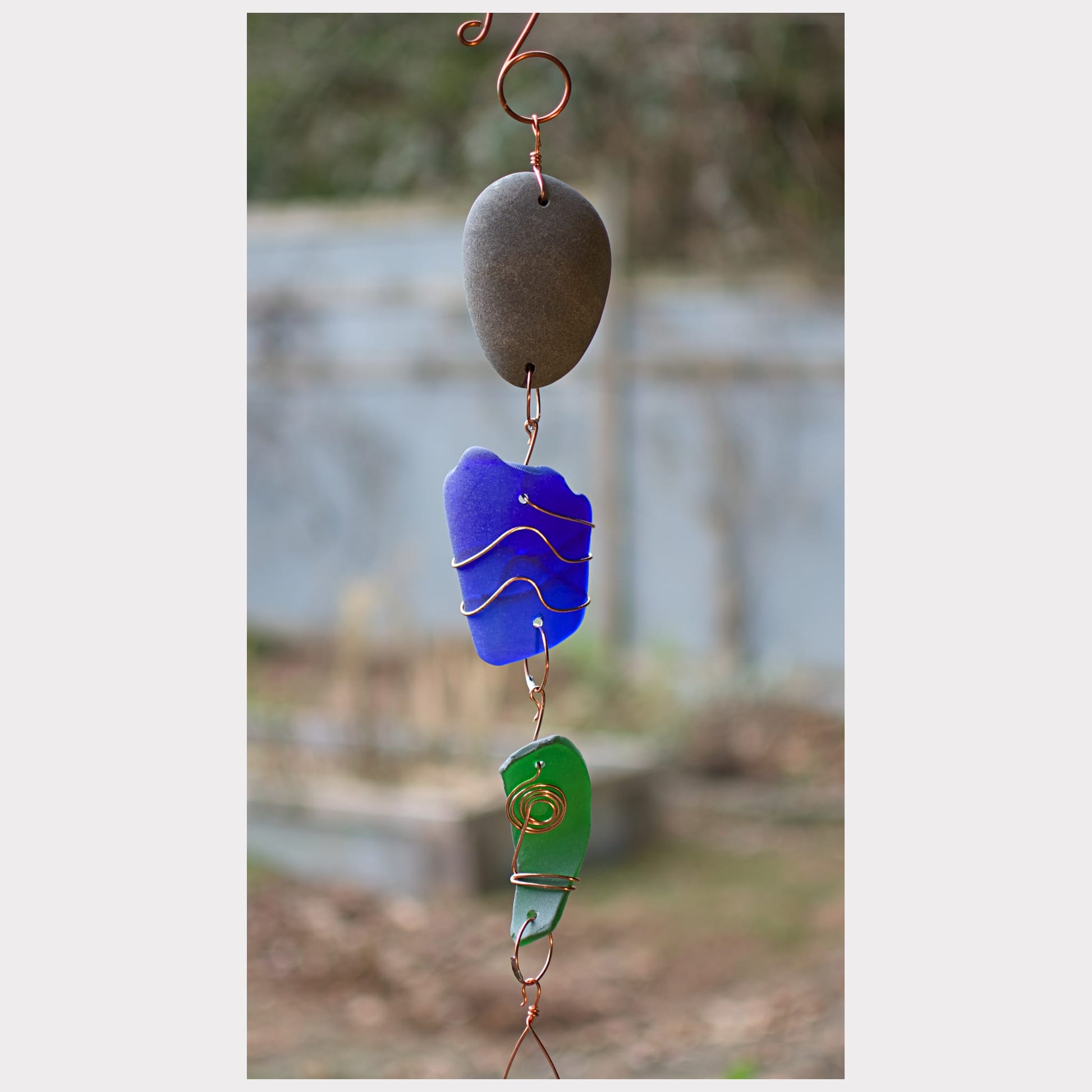 detail, outdoor beach stone sea glass wind chime