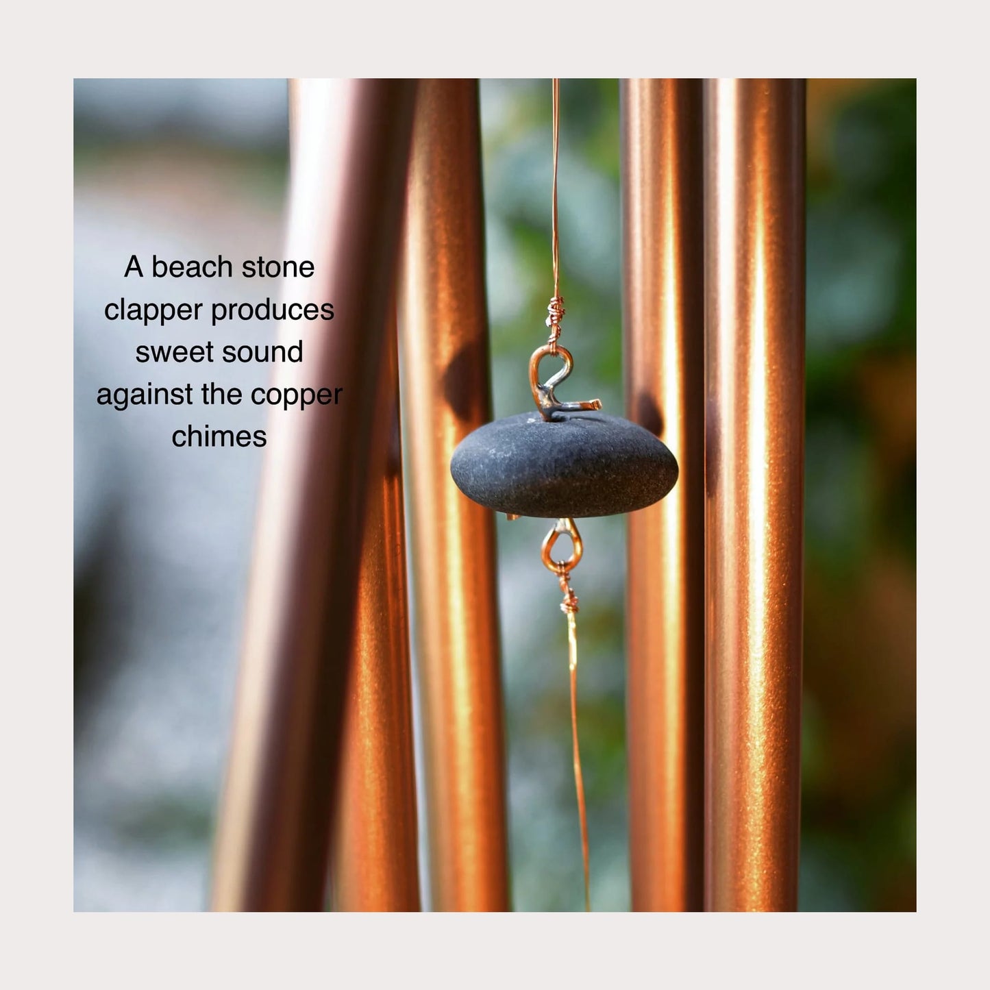 a beach stone clapper for copper wind chimes