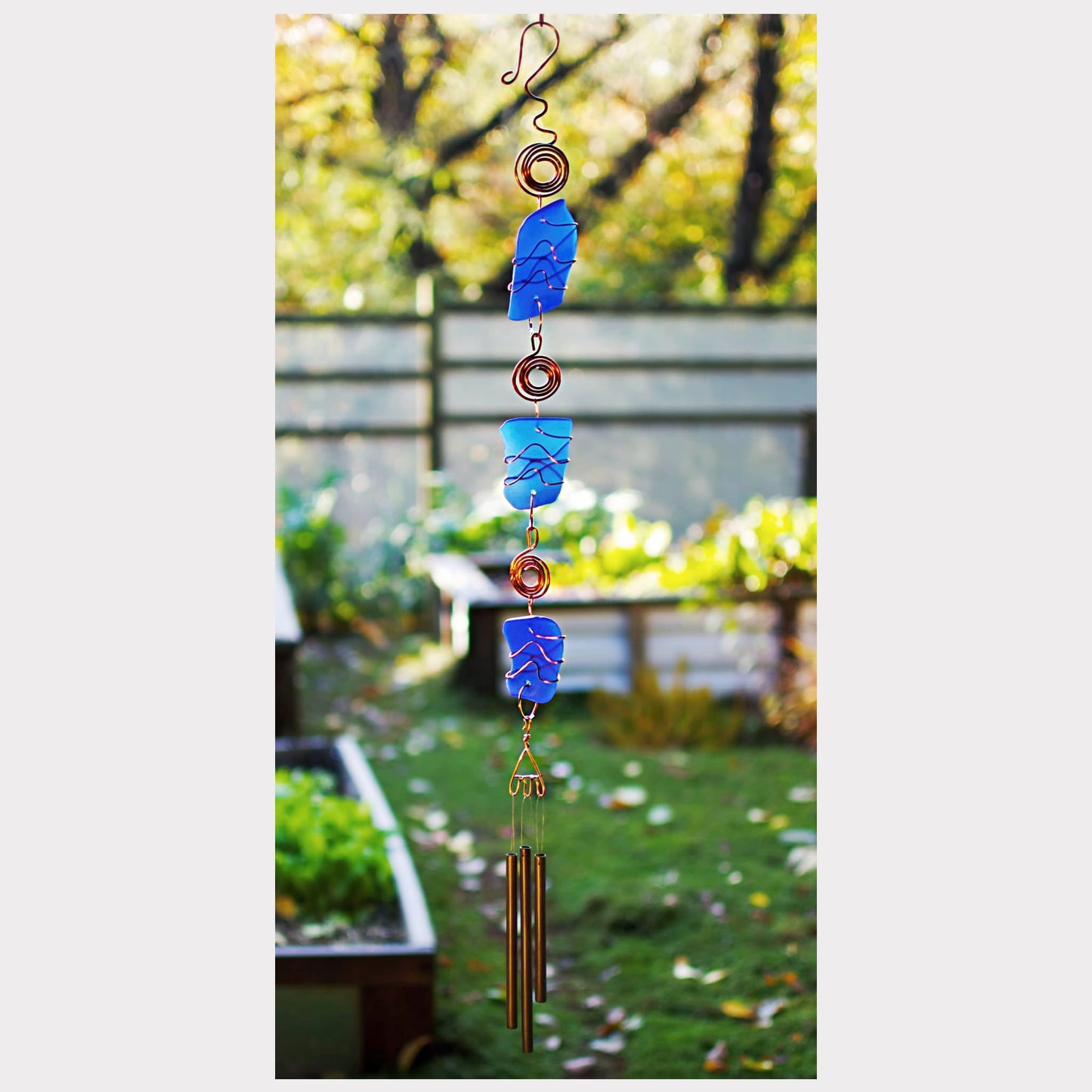 Handcrafted cobalt blue sea glass wind chime with brass chimes.