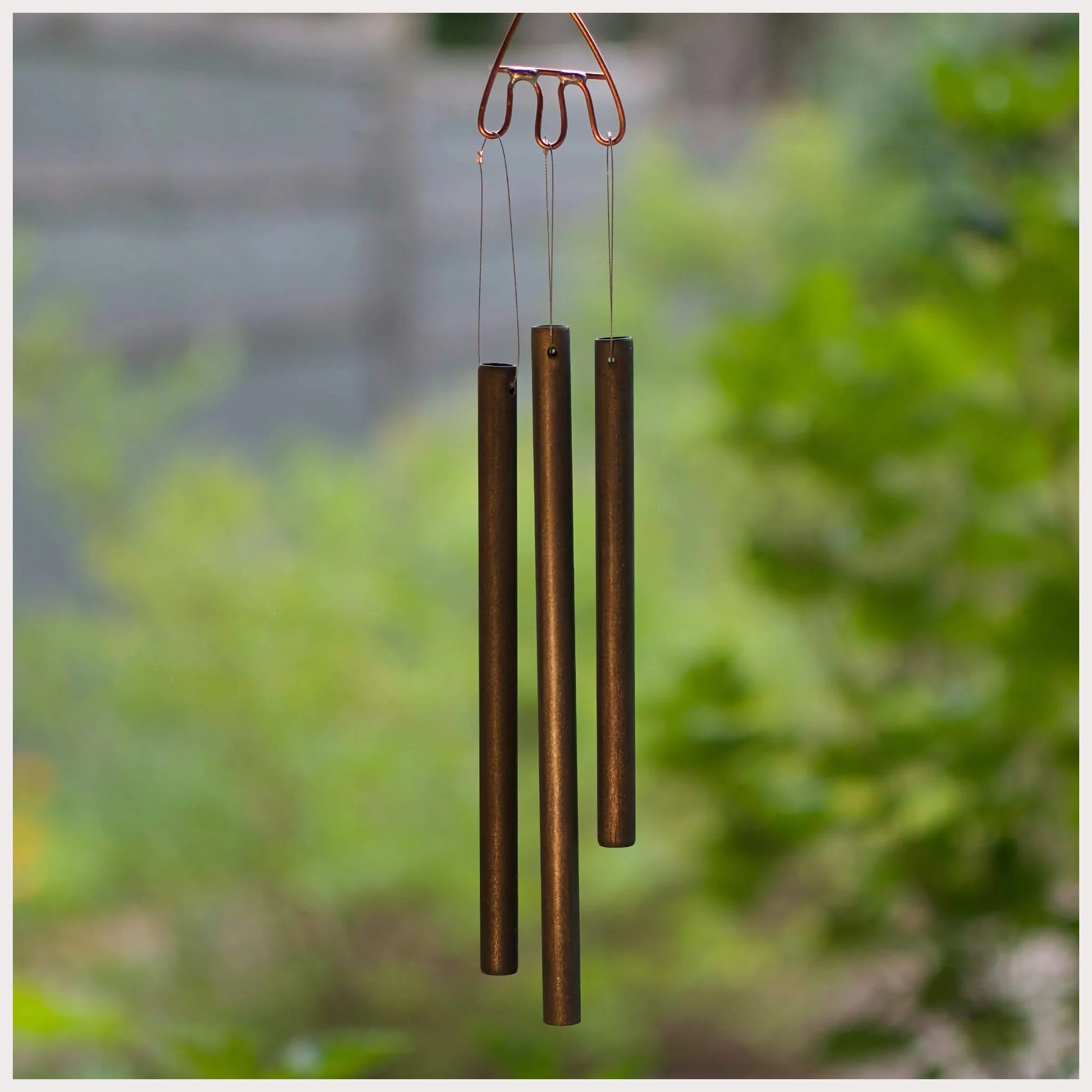 Handmade antiqued brass chimes, made by Coast Chimes.