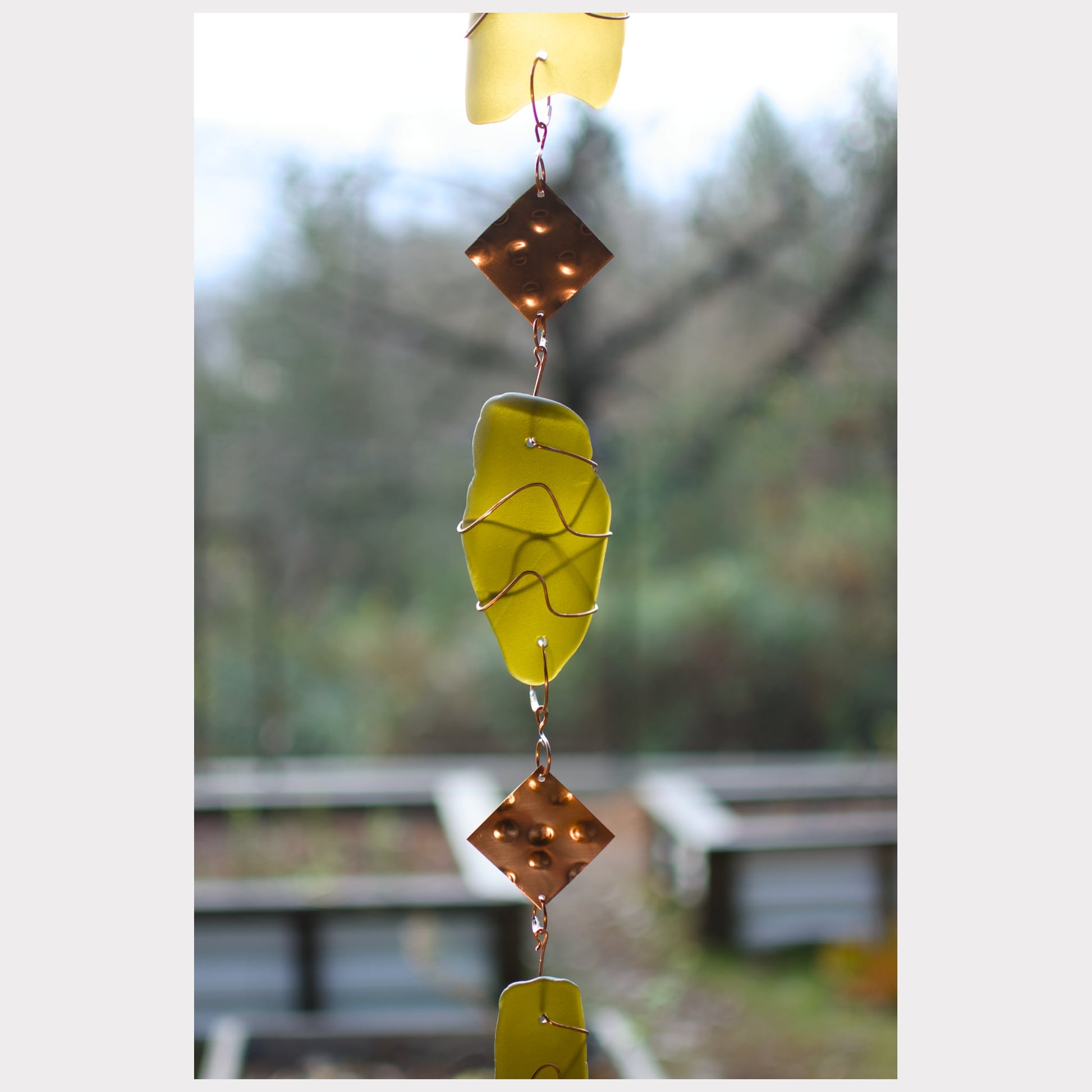 zoom detail, glass and copper wind chime