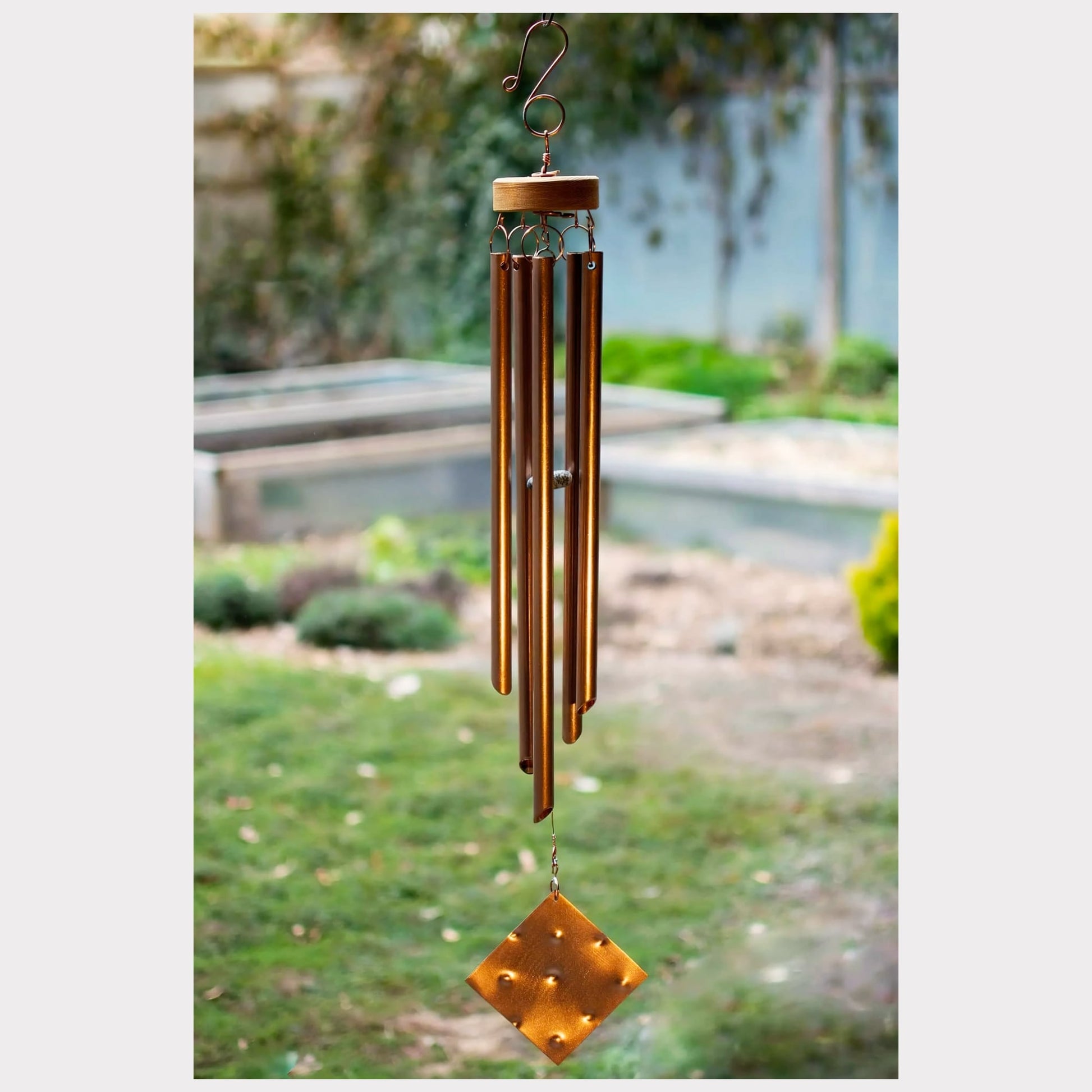 Handmade copper wind chime with a hammered copper windsail.