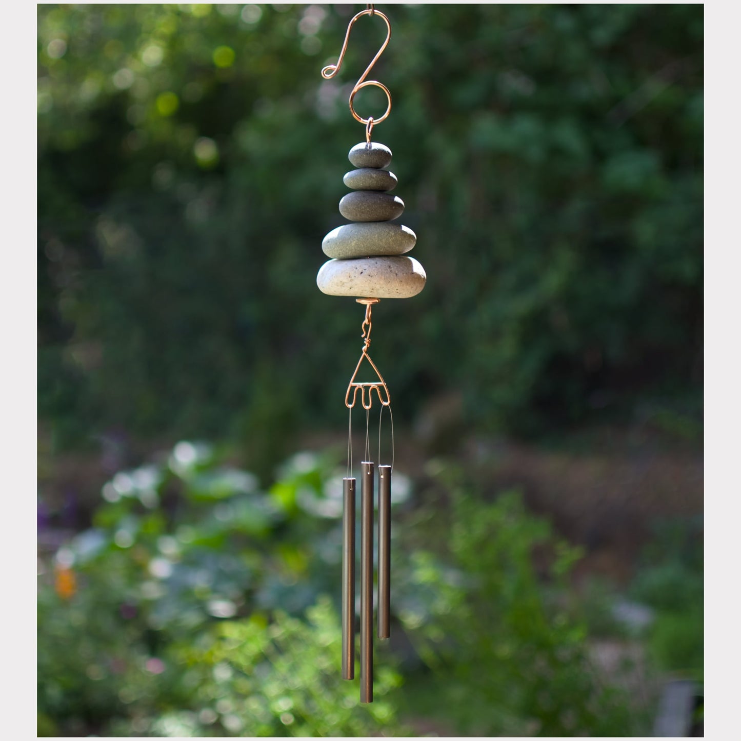 Zen wind chime featuring five natural beach stones and three antiqued brass chimes.
