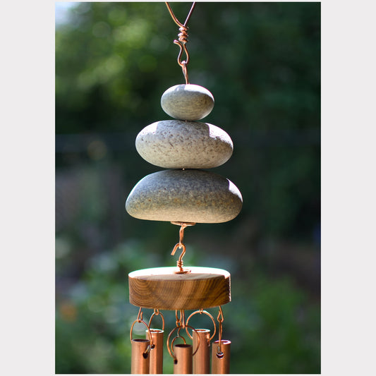 Detail, large natural beach stone wind chime.