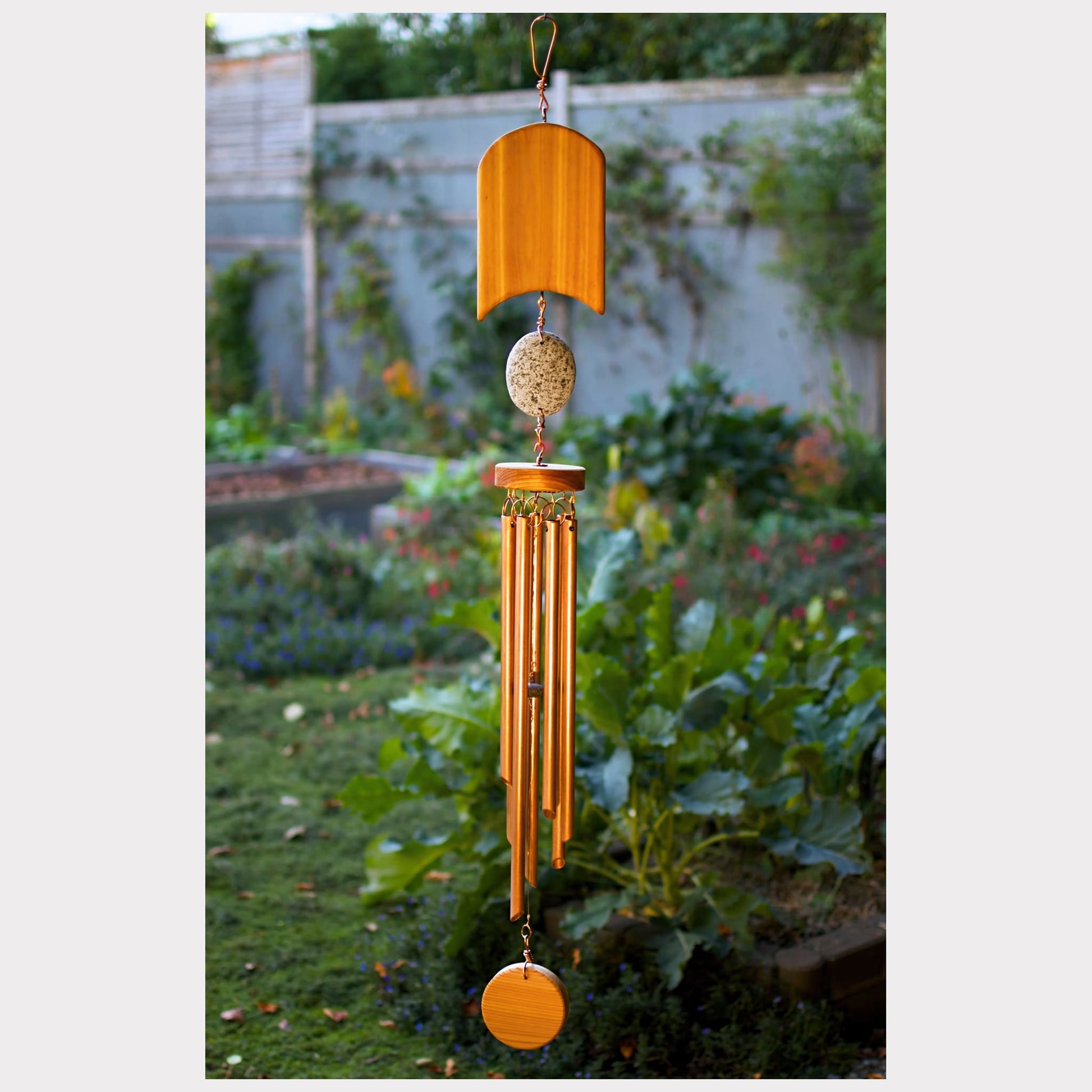 Cedar, beach stone, and copper wind chime.